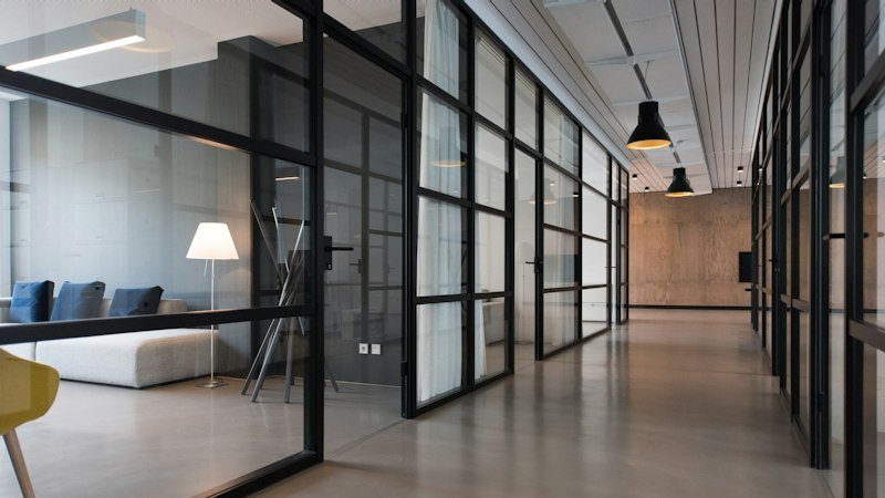 Foundry Row: the top-lit spine of the old foundry, lined with steel-framed glazed partitions into the studios