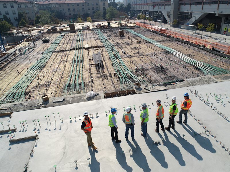 Construction team on a concrete slab in early works